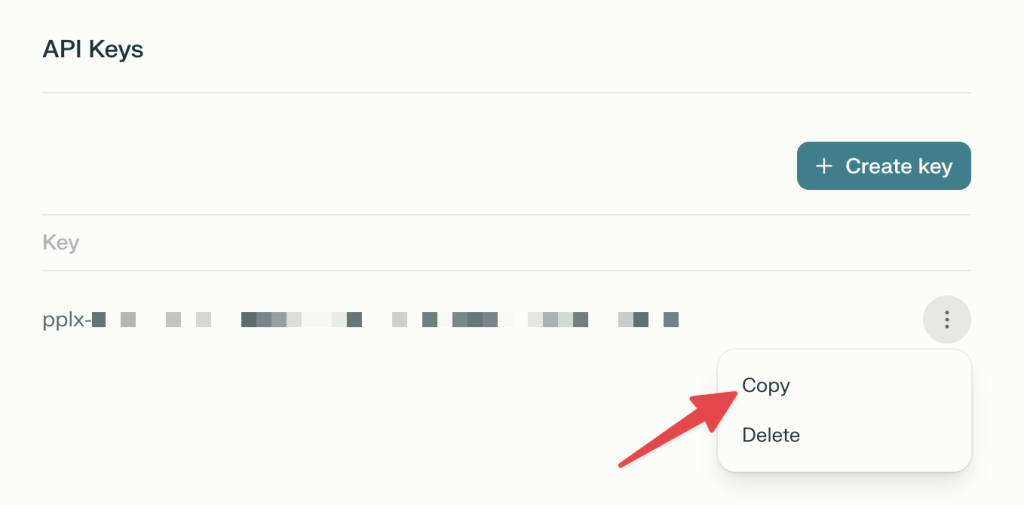 Perplexity API keys page showing a generated API key with a red arrow pointing to the “Copy” button.